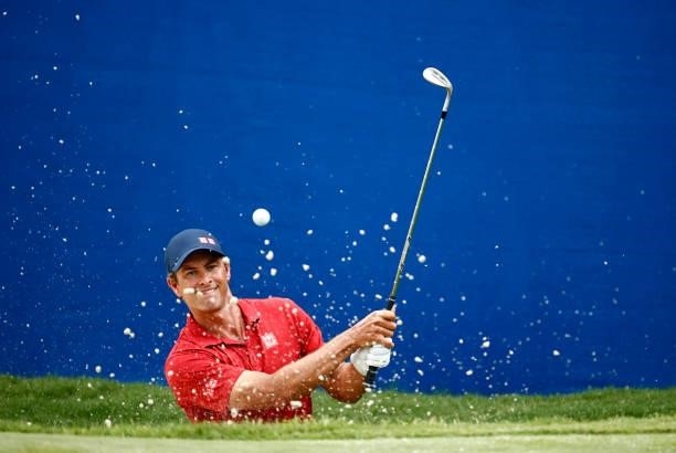 Adam Scott of Australia plays a shot from a greenside bunker on the 18th hole during the final round of the Wyndham Championship at Sedgefield...