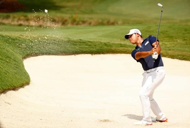 Si Woo Kim of South Korea plays a shot from a greenside bunker on the 18th hole, the second-playoff hole in a six-way sudden-death playoff, during...