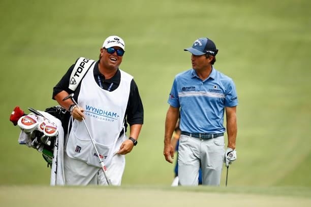 Kevin Kisner of the United States and caddie Duane Bock walk up the 18th fairway, the first-playoff hole in a six-way sudden-death playoff, during...