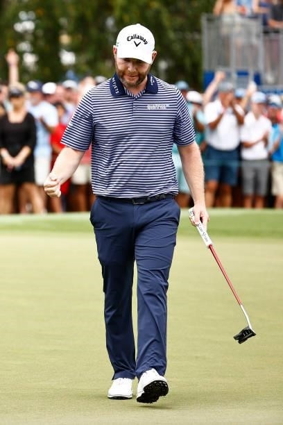 Branden Grace of South Africa celebrates his birdie putt on the 18th green during the final round of the Wyndham Championship at Sedgefield Country...