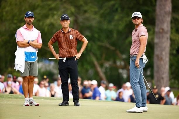Kevin Na of the United States and Roger Sloan of Canada wait on the 18th green during the final round of the Wyndham Championship at Sedgefield...