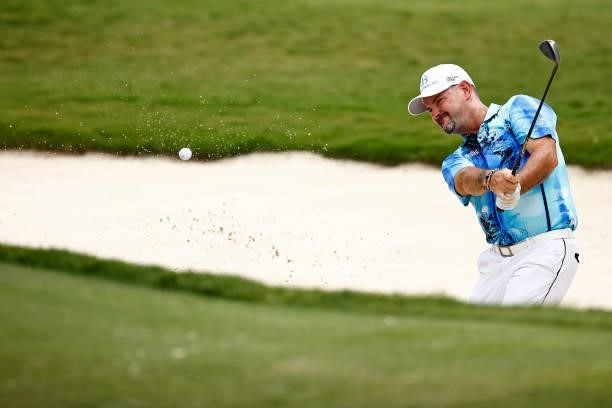 Rory Sabbatini of Slovakia plays a shot from a bunker on the 18th hole during the final round of the Wyndham Championship at Sedgefield Country Club...