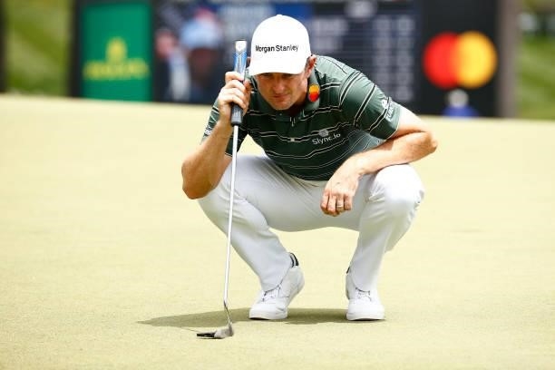 Justin Rose of England lines up a putt on the 18th green during the final round of the Wyndham Championship at Sedgefield Country Club on August 15,...
