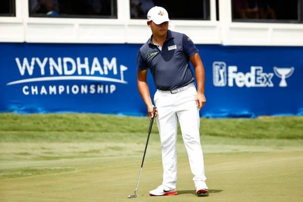 Si Woo Kim of South Korea watches his putt on the 18th green during the final round of the Wyndham Championship at Sedgefield Country Club on August...