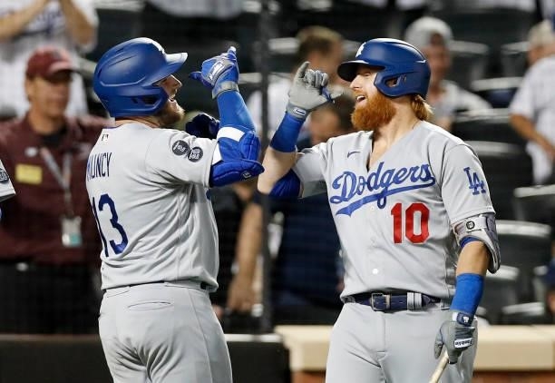Max Muncy of the Los Angeles Dodgers celebrates his two-run home run with Justin Turner against the New York Mets in the sixth inning at Citi Field...