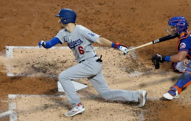 Trea Turner of the Los Angeles Dodgers hits an RBI double against the New York Mets in the second inning at Citi Field on August 15, 2021 in New York...