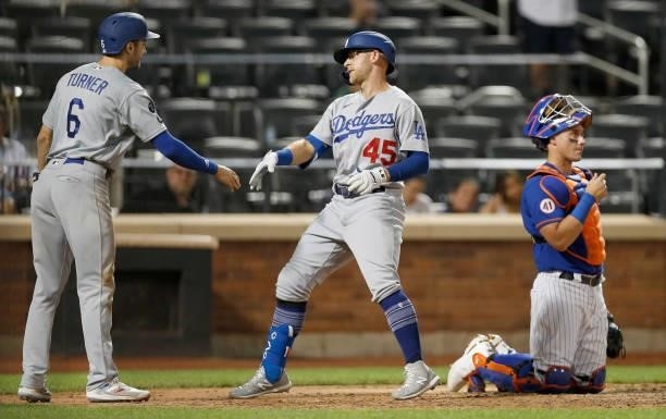 James McCann of the New York Mets looks on as Matt Beaty of the Los Angeles Dodgers celebrates his ninth inning two run home run with teammate Trea...
