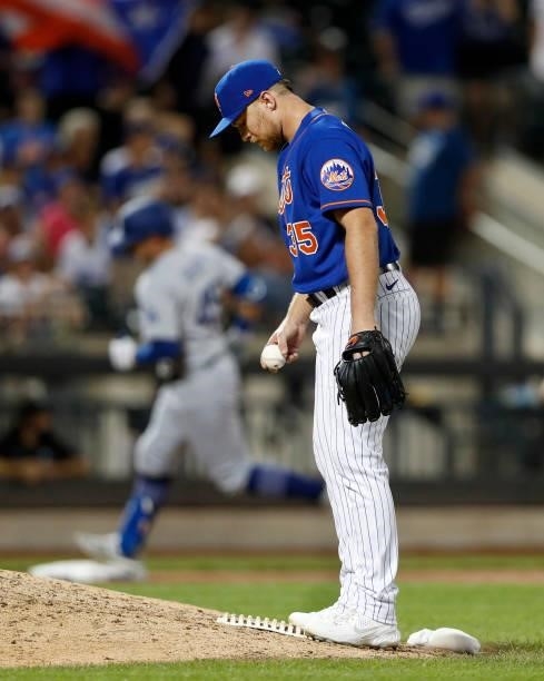 Brandon Drury of the New York Mets stands on the mound after surrendering a ninth inning two run home run against Matt Beaty of the Los Angeles...
