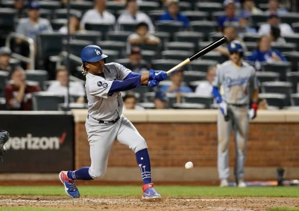 Edwin Uceta of the Los Angeles Dodgers connects on his eighth inning infield base hit against the New York Mets at Citi Field on August 15, 2021 in...