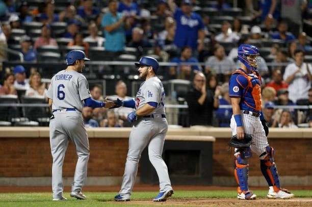 Max Muncy of the Los Angeles Dodgers celebrates his sixth inning two run home run against the New York Mets with teammate Trea Turner at Citi Field...