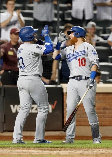 Max Muncy of the Los Angeles Dodgers celebrates his sixth inning two run home run against the New York Mets with teammate Justin Turner at Citi Field...