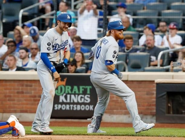 Justin Turner celebrates his first inning two run home run against the New York Mets with teammate Trea Turner at Citi Field on August 15, 2021 in...