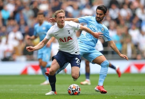 Oliver Skipp of Tottenham Hotspur holds off a challenge from Ilkay Gundogan of Manchester City during the Premier League match between Tottenham...