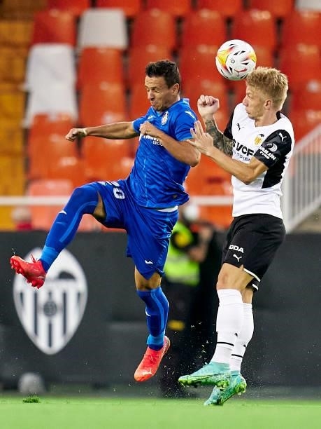 Daniel Wass of Valencia CF competes for the ball with Nemanja Maksimovic of Getafe CF during the La Liga Santander match between Valencia CF and...