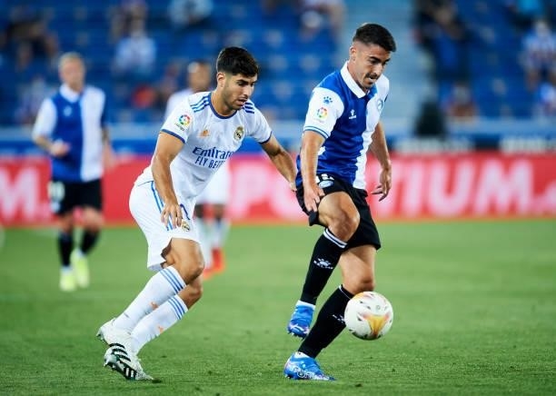 Marco Asensio of Real Madrid duels for the ball with Toni Moya of Deportivo Alaves during the LaLiga Santader match between Deportivo Alaves and Real...
