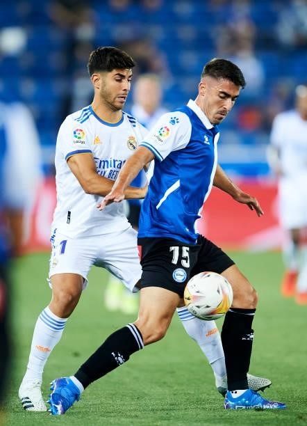 Marco Asensio of Real Madrid duels for the ball with Toni Moya of Deportivo Alaves during the LaLiga Santader match between Deportivo Alaves and Real...