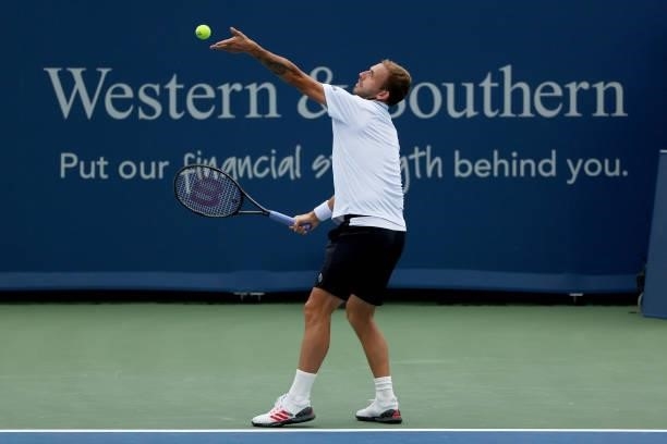 Daniel Evans of Great Britain serves during his match against Diego Schwartzman of Argentina during the Western & Southern Open - Day 2 at Lindner...