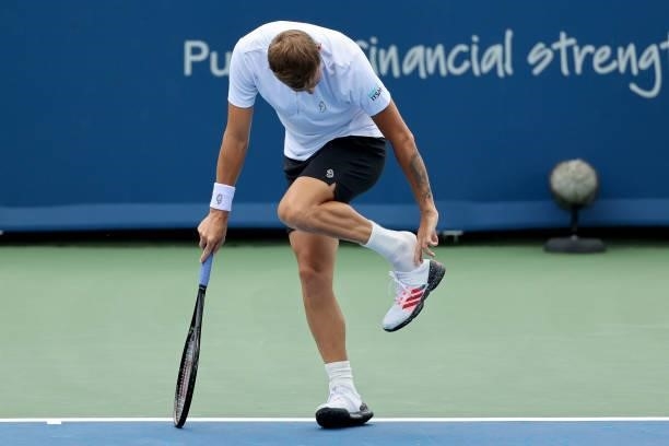 Daniel Evans of Great Britain adjusts his shoe during his match against Diego Schwartzman of Argentina during the Western & Southern Open - Day 2 at...