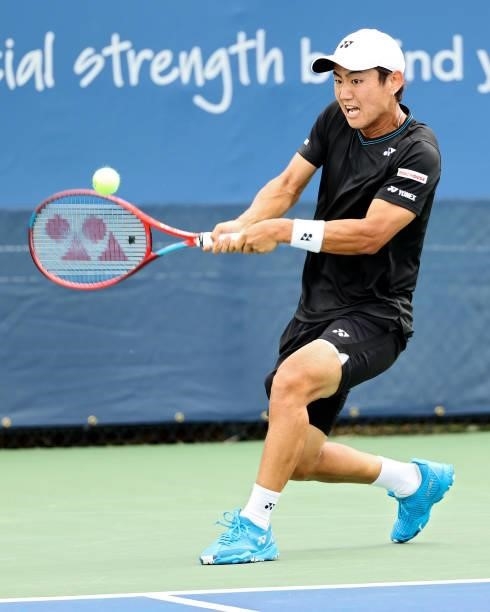 Yoshihito Nishioka of Japan plays a backhand during his match against Lloyd Harris of South Africa during the Western & Southern Open - Day 2 at...