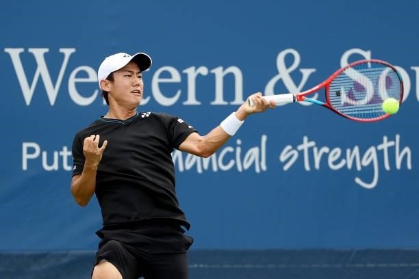 Yoshihito Nishioka of Japan plays a forehand during his match against Lloyd Harris of South Africa during the Western & Southern Open - Day 2 at...