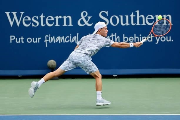 Diego Schwartzman of Argentina plays a backhand during his match against Daniel Evans of Great Britain during the Western & Southern Open - Day 2 at...