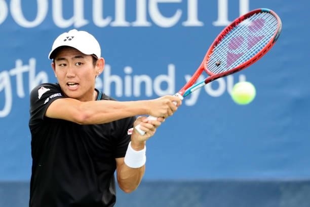Yoshihito Nishioka of Japan plays a backhand during his match against Lloyd Harris of South Africa during the Western & Southern Open - Day 2 at...