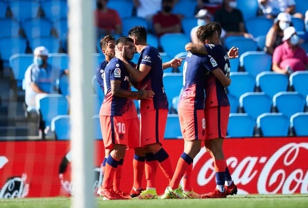 Angel Correa of Atletico de Madrid celebrates with team mates after scoring their side's second goal during the LaLiga Santander match between RC...