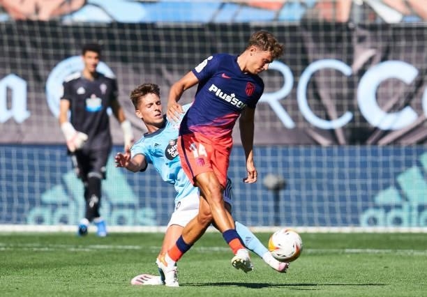 Marcos Llorenteof Club Atletico de Madrid duels for the ball with Jose Fontan of Celta de Vigo during the LaLiga Santander match between RC Celta de...