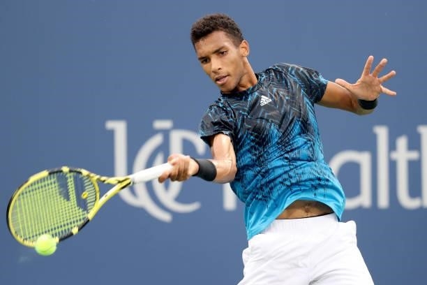 Felix Auger-Aliassime of Canada returns a shot to Marlon Fucsovics of Hungary during the Western & Southern Open at Lindner Family Tennis Center on...