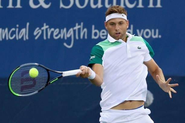 Filip Krajinovic of Serbia plays a forehand during his match against Alex de Minaur of Australia during the Western & Southern Open - Day 2 at...