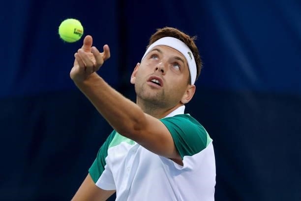 Filip Krajinovic of Serbia serves during his match against Alex de Minaur of Australia during the Western & Southern Open - Day 2 at Lindner Family...