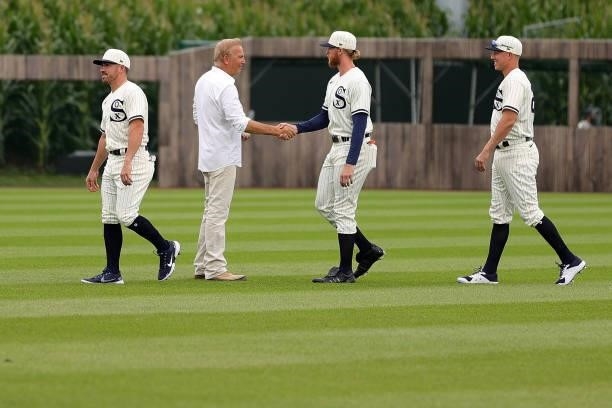 Michael Kopech of the Chicago White Sox shakes hands with actor Kevin Costner prior to a game against the New York Yankees at the Field of Dreams on...