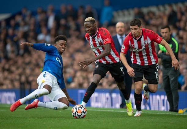 Moussa Djenepo and Romain Perraud of Southampton in action with Demarai Gray of Everton during the Premier League match between Everton and...