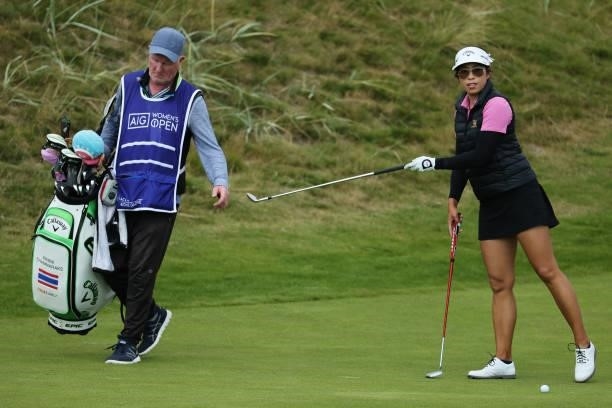 Prima Thammaraks of Thailand passes a club to her caddie during a practice round prior to the AIG Women's Open at Carnoustie Golf Links on August 17,...