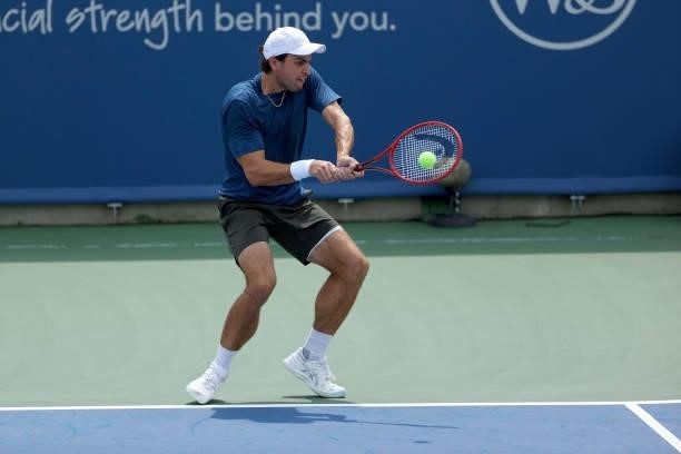 Aslan Karatsev of Russia plays a backhand during his match against Marin Cilic of Croatia during Western & Southern Open - Day 3 at Lindner Family...