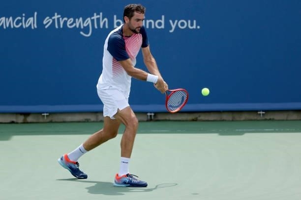 Marin Cilic of Croatia plays a backhand during his match against Aslan Karatsev of Russia during Western & Southern Open - Day 3 at Lindner Family...