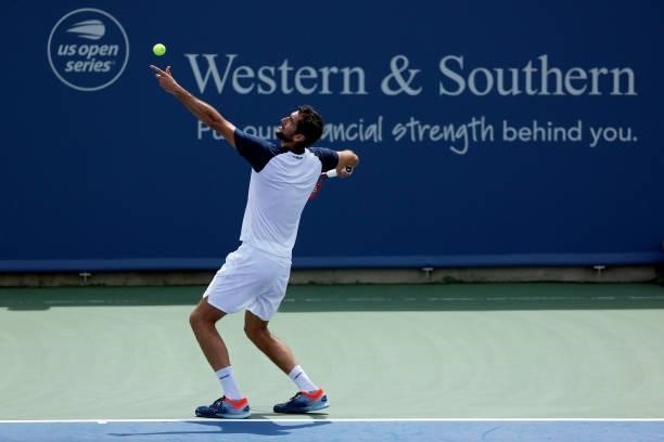 Marin Cilic of Croatia serves during his match against Aslan Karatsev of Russia during Western & Southern Open - Day 3 at Lindner Family Tennis...