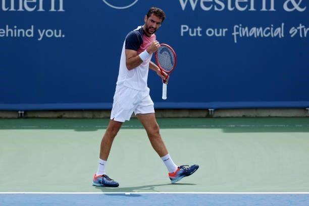 Marin Cilic of Croatia reacts after winning a point during his match against Aslan Karatsev of Russia during Western & Southern Open - Day 3 at...