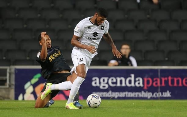 Zak Jules of Milton Keynes Dons moves with the ball past the challenge of Akin Famewo of Charlton Athletic during the Sky Bet League One match...