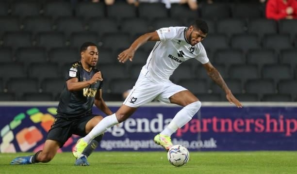 Zak Jules of Milton Keynes Dons moves with the ball past the challenge of Akin Famewo of Charlton Athletic during the Sky Bet League One match...