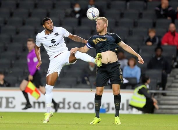 Zak Jules of Milton Keynes Dons contests the ball with Jayden Stockley of Charlton Athletic during the Sky Bet League One match between Milton Keynes...