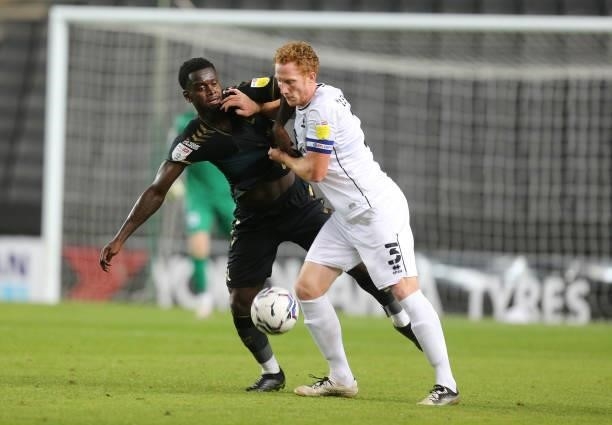 Dean Lewington of Milton Keynes Dons contests the ball with Daillang Jaiyesimi of Charlton Athletic during the Sky Bet League One match between...