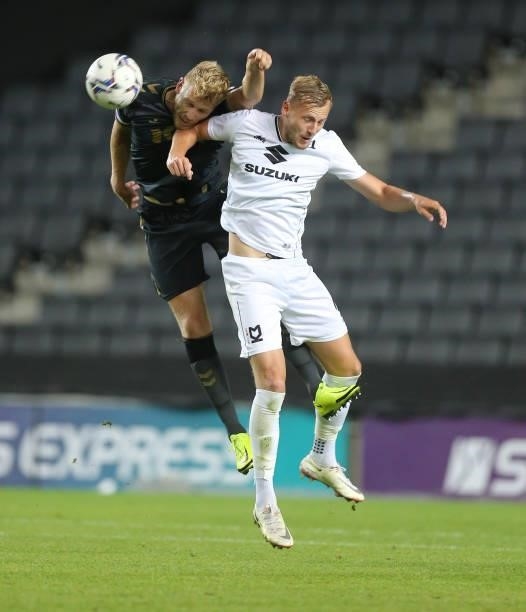 Harry Darling of Milton Keynes Dons contests the ball with Jayden Stockley of Charlton Athletic during the Sky Bet League One match between Milton...