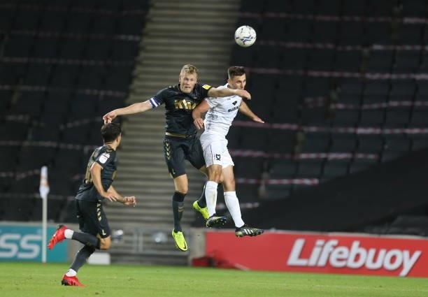 Jayden Stockley of Charlton Athletic contests the ball with Warren O'Hora of Milton Keynes Dons during the Sky Bet League One match between Milton...