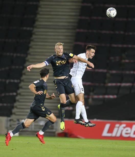 Jayden Stockley of Charlton Athletic contests the ball with Warren O'Hora of Milton Keynes Dons during the Sky Bet League One match between Milton...