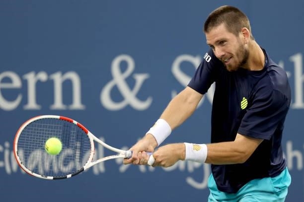 Cameron Norrie of Great Britain returns a shot to John Isner during the Western & Southern Open at Lindner Family Tennis Center on August 17, 2021 in...