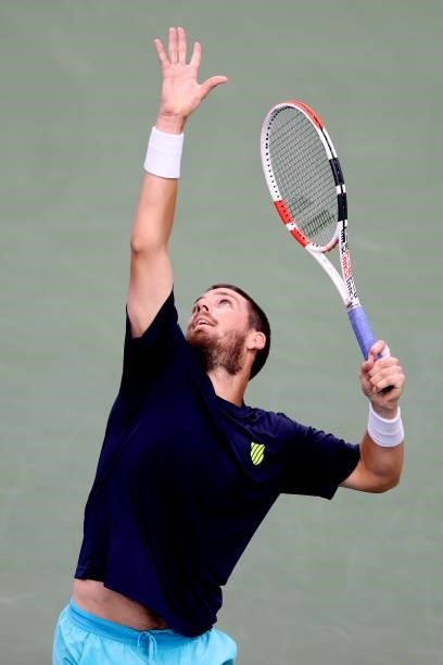 Cameron Norrie of Great Britain serves to John Isner during the Western & Southern Open at Lindner Family Tennis Center on August 17, 2021 in Mason,...