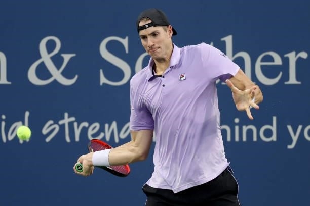 John Isner returns a shot to Cameron Norrie of Great Britain during the Western & Southern Open at Lindner Family Tennis Center on August 17, 2021 in...