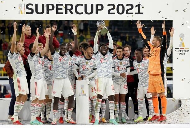 Alphonso Davies of Muenchen lifts the trophy after winning the Supercup 2021 match between FC Bayern München and Borussia Dortmund at Signal Iduna...