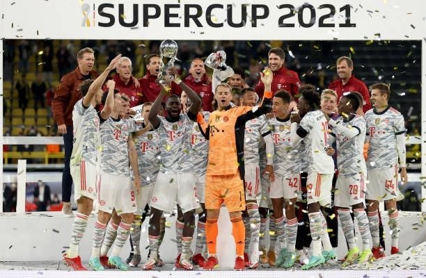 Dayot Upamecano of Muenchen lifts the trophy after winning the Supercup 2021 match between FC Bayern München and Borussia Dortmund at Signal Iduna...